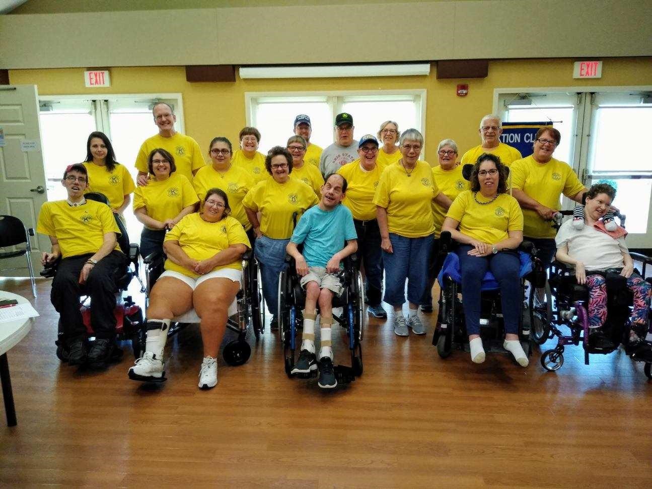 group of adults in yellow matching shirts